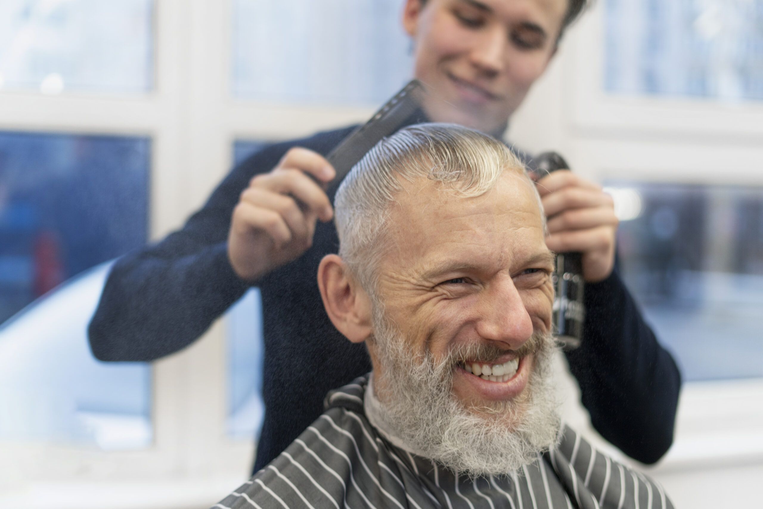 close-up-smiley-man-hair-salon